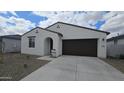 Charming single-story home featuring a two-car garage, low maintenance yard, and stucco siding at 37600 N Cowboy Ln, San Tan Valley, AZ 85140