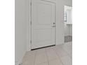 Bright entryway with tile flooring, white door, and view of a walk-in closet at 7449 S 75Th Dr, Laveen, AZ 85339