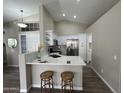 Modern kitchen with white cabinets, stainless steel appliances, and marble countertops at 15075 W Amelia Dr, Goodyear, AZ 85395