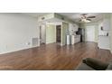 Open-concept living area showcasing hardwood floors and seamless flow to kitchen at 3345 E University Dr # 2, Mesa, AZ 85213