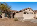 Single-story house with a two-car garage and mature tree at 574 W Kingman Dr, Casa Grande, AZ 85122