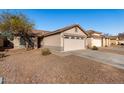 House exterior showcasing a two-car garage and neighborhood view at 574 W Kingman Dr, Casa Grande, AZ 85122