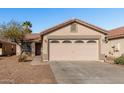 Front view of a single-story house with a two-car garage at 574 W Kingman Dr, Casa Grande, AZ 85122