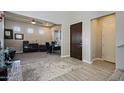 Bright entryway with wood-look floors and home office at 7325 E Conquistadores Dr, Scottsdale, AZ 85255