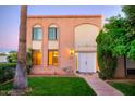Brick building exterior with a lush lawn and walkway at 7662 E Minnezona Ave, Scottsdale, AZ 85251