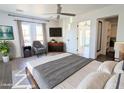 Spacious main bedroom with a king-size bed and access to a balcony at 7662 E Minnezona Ave, Scottsdale, AZ 85251