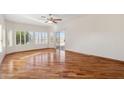 Sunlit bedroom features hardwood floors, a ceiling fan, and views of the water at 770 S Ocean Dr, Gilbert, AZ 85233
