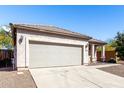 Charming single-story home with a two car garage and desert landscaping at 26058 W Yukon Dr, Buckeye, AZ 85396