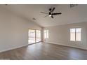 Bright living room with vinyl flooring and sliding door to patio at 3011 E Colonial Pl, Chandler, AZ 85249