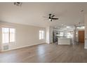 Open concept living room, kitchen, and dining area with vinyl flooring at 3011 E Colonial Pl, Chandler, AZ 85249