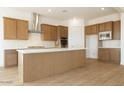 A kitchen featuring wood cabinets, stainless appliances, a large island, and tile backsplash at 829 W Golden Ore Pass, Apache Junction, AZ 85120