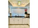 Modern kitchen with white cabinets, black countertops, and stainless steel appliances at 272 Leisure World --, Mesa, AZ 85206