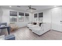 Bright living room, featuring a sectional sofa and large windows at 3714 S 58 Dr, Phoenix, AZ 85043