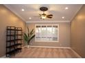 Well-lit room with neutral walls, plush carpeting, and a large window at 2116 N 81St Cir, Mesa, AZ 85207