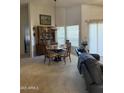 Bright dining area with a chandelier, comfortable seating for four, and sliding glass doors leading to the patio at 402 W Grandview Rd, Phoenix, AZ 85023