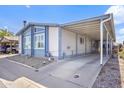 Single story home featuring carport, desert landscaping, and easy access at 11275 N 99Th Ave # 145, Peoria, AZ 85345