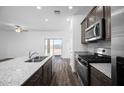 Modern kitchen features stainless steel appliances, center island and views to the outdoor space at 24592 W St Anne Ave, Buckeye, AZ 85326