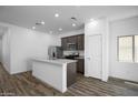 Bright, open kitchen area with stainless steel appliances, granite countertops and a center island at 24593 W St Catherine Ave, Buckeye, AZ 85326