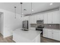 Modern kitchen with stainless steel appliances, white cabinets and a center island at 18532 E Dario Rd, Gold Canyon, AZ 85118