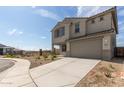 Charming two-story home featuring a two-car garage, long driveway, and desert landscaping at 8512 N 170Th Ln, Waddell, AZ 85355