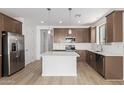 Modern kitchen features stainless steel appliances, an island with bar seating, and stylish pendant lighting at 18525 E Dario Rd, Gold Canyon, AZ 85118