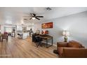 Spacious open-concept living room featuring wood floors and desk, leading to a modern kitchen at 1413 E Windsor Ave, Phoenix, AZ 85006