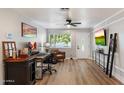 Inviting living room with wood floors, neutral walls, ceiling fan, and a stylish workstation by the front door at 1413 E Windsor Ave, Phoenix, AZ 85006