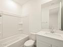 Clean bathroom with a bathtub, toilet, and vanity at 37405 W San Clemente St, Maricopa, AZ 85138