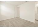 Spacious bedroom with neutral carpeting and an ensuite bathroom at 37405 W San Clemente St, Maricopa, AZ 85138