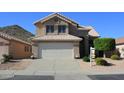 Inviting two-story home featuring a spacious driveway, mature landscaping, and a well-maintained front yard at 1926 E Siesta Ln, Phoenix, AZ 85024