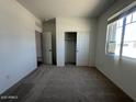 Comfortable bedroom with a closet and carpeted floor, offering a blank canvas for personalization at 46963 W Coe St, Maricopa, AZ 85139