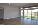 An expansive living room showcasing a wall of sliding glass doors offering scenic backyard views at 32513 N 135Th Dr, Peoria, AZ 85383