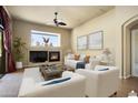 Cozy living room featuring a fireplace, plush seating, and neutral walls, enhanced by tasteful decor at 2606 N 159Th Dr, Goodyear, AZ 85395