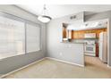 Bright dining area with a window view and a convenient pass-through to the adjacent kitchen at 4925 E Desert Cove Ave # 350, Scottsdale, AZ 85254