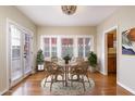 Cozy dining room area with wicker furniture, lovely windows, and warm lighting, perfect for intimate gatherings at 1346 W Willetta St, Phoenix, AZ 85007
