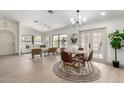 Open-concept living area with a dining space featuring light wood floors and abundant natural light at 2107 S Paseo Loma --, Mesa, AZ 85202