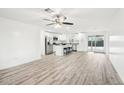 Spacious living room with wood-look flooring at 6010 W Lewis Ave, Phoenix, AZ 85035