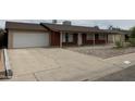 Exterior view of home featuring an attached garage and desert landscaping at 4232 W Citrus Way, Phoenix, AZ 85019