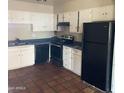 Functional kitchen with white cabinetry and black appliances at 4147 W Reade Ave, Phoenix, AZ 85019