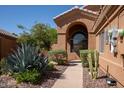 Landscaped walkway leading to the arched entryway at 1416 E Sapium Way, Phoenix, AZ 85048