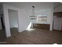 Bright dining room with hardwood floors and stylish lighting at 21601 W Mariposa St, Buckeye, AZ 85396