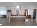 Modern kitchen featuring an island, stainless steel appliances, and white cabinets at 21601 W Mariposa St, Buckeye, AZ 85396