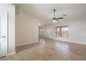 Open concept living room with tile flooring, natural light and neutral color palette at 8464 W Royal Blackheath Dr, Arizona City, AZ 85123