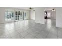 Bright living room with tile floors and sliding glass doors leading to the backyard at 7119 W Jenan Dr, Peoria, AZ 85345