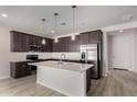 Modern kitchen featuring stainless steel appliances, dark cabinetry, and a large island at 18714 E Panchito Dr, Gold Canyon, AZ 85118