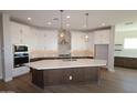 Modern kitchen featuring white cabinets, stainless steel appliances, and a large island at 1042 W Ridge Rd, Apache Junction, AZ 85120