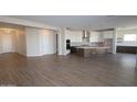 Open-concept living space with tile floors leading into a modern kitchen at 1042 W Ridge Rd, Apache Junction, AZ 85120