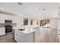 Modern kitchen with stainless appliances, a breakfast bar and an open floorplan flowing into the bright living space at 18762 E Panchito Dr, Gold Canyon, AZ 85118