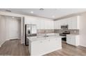 Spacious kitchen with stainless steel appliances, a large center island, and stylish, light-colored backsplash at 18762 E Panchito Dr, Gold Canyon, AZ 85118