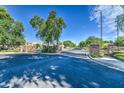 Gated community entrance with tree-lined streets, well-maintained landscaping, and upscale homes at 1695 E Mia Ln, Gilbert, AZ 85298